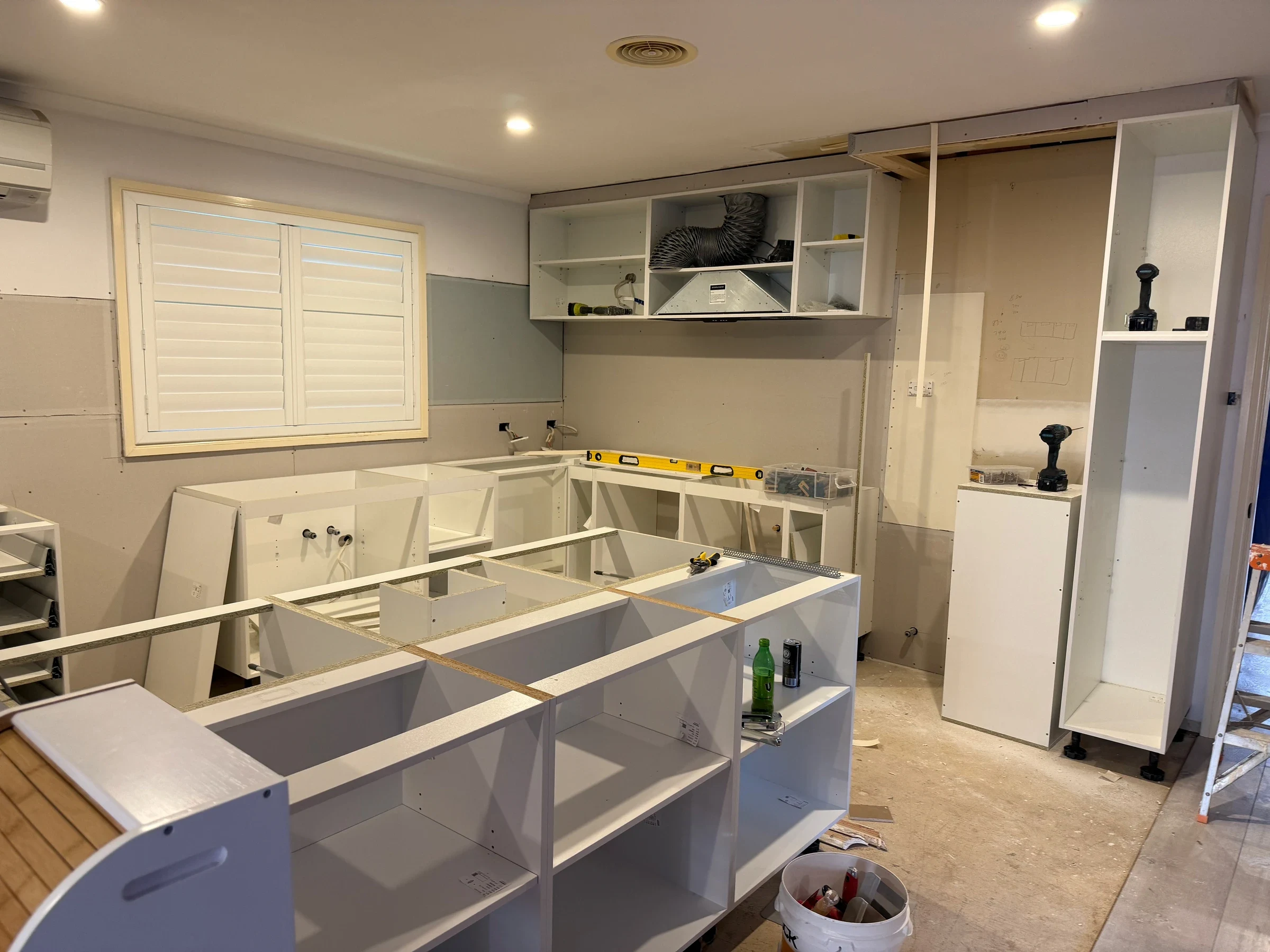The same Bluestone kitchen during cabinetry installation, before the stone benchtops and cabinet doors