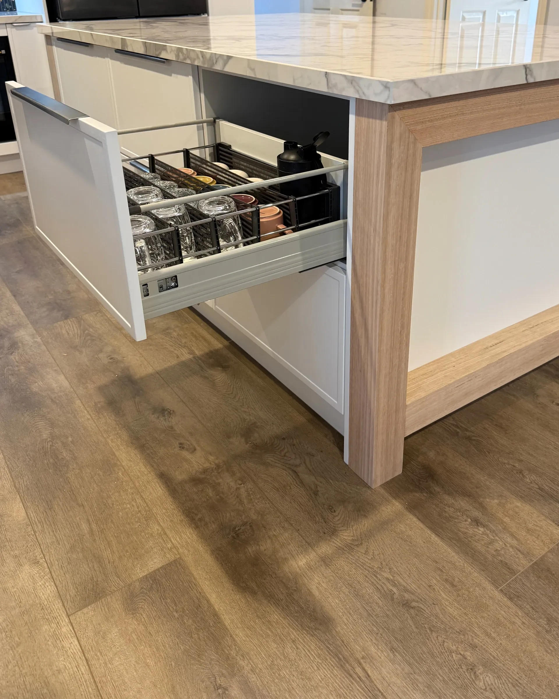 Open island drawer with cups and glasses