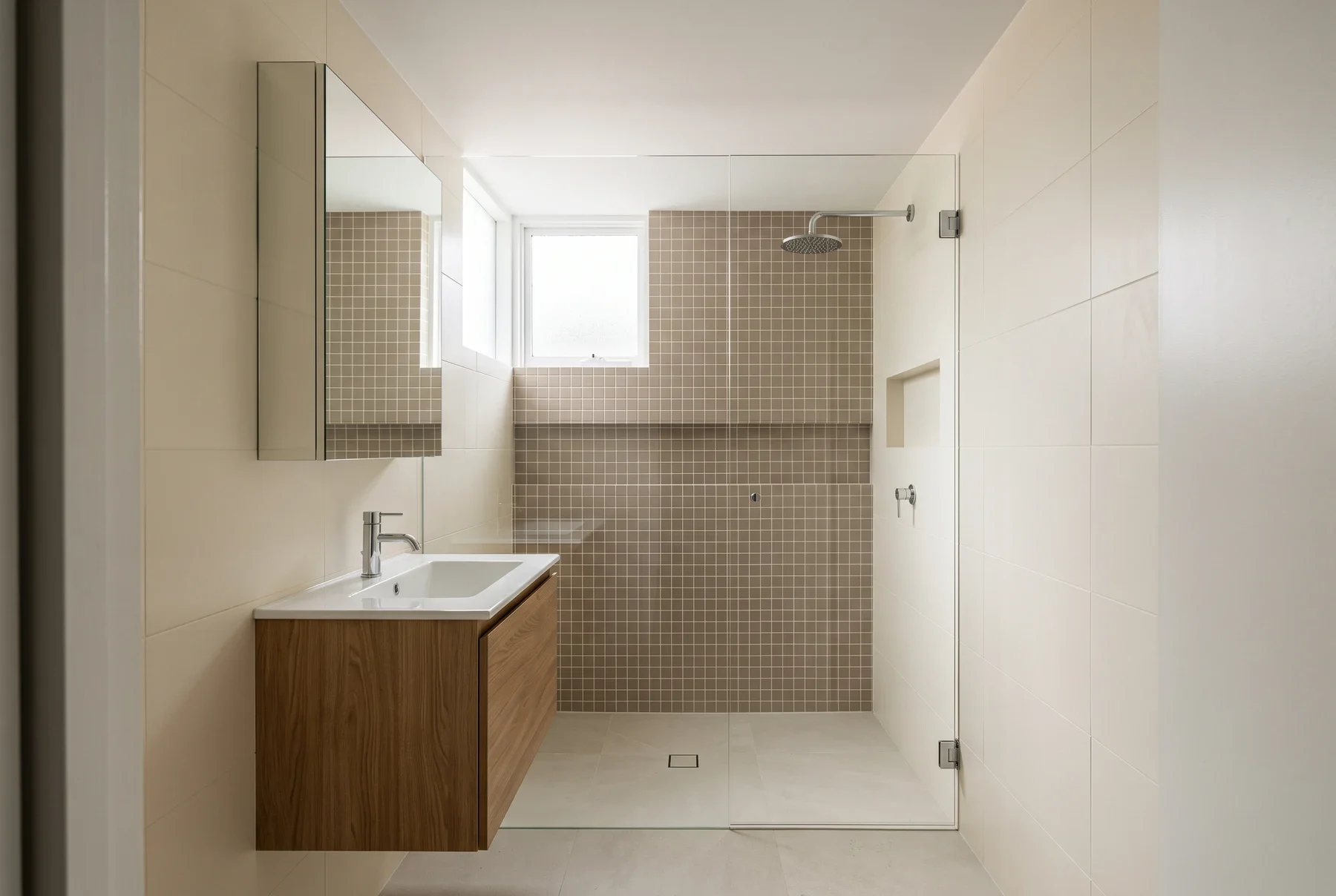 Compact bathroom inspiration with clay square shower tiles, cream walls and an oak vanity