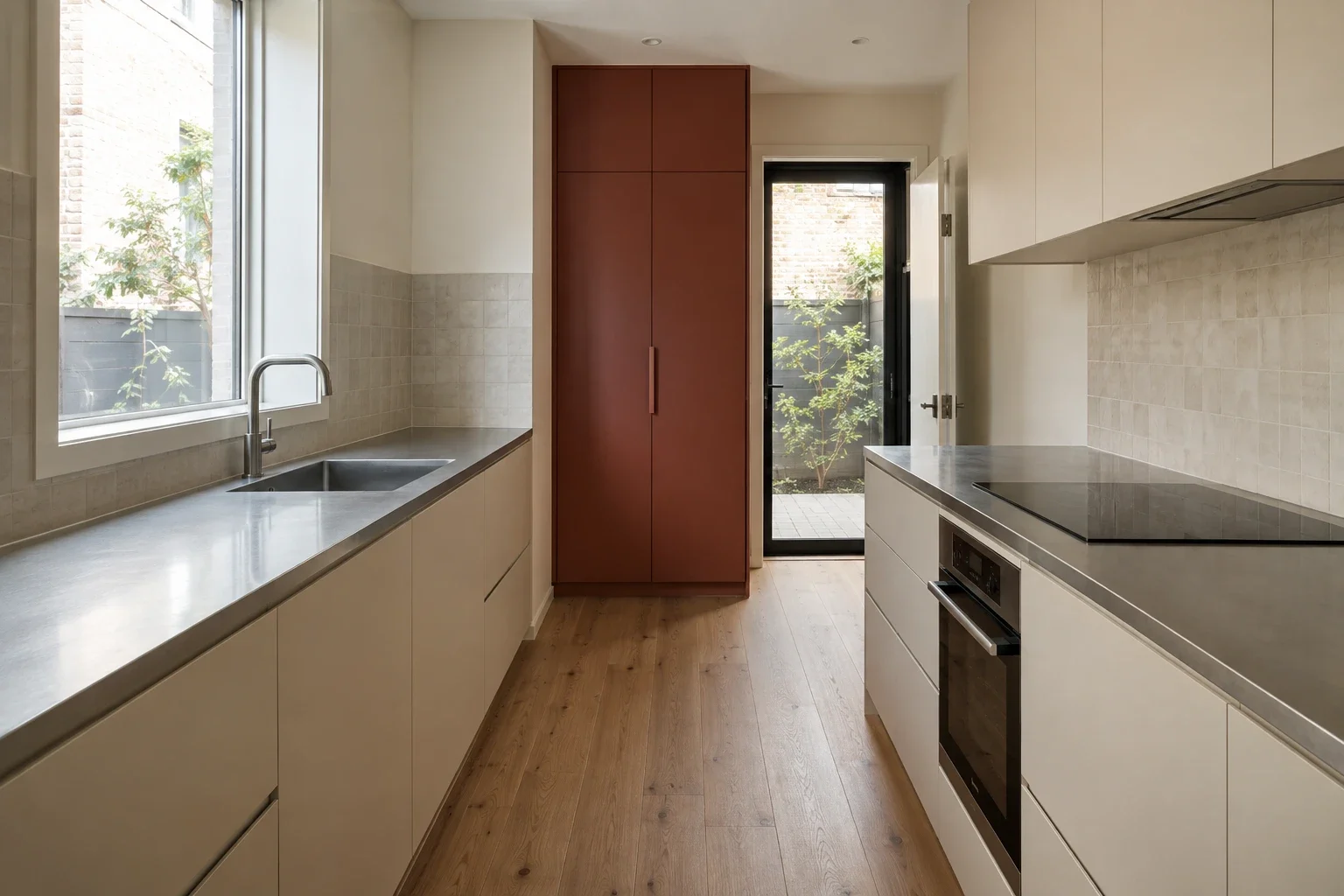 A rust-red pantry in a narrow kitchen — kitchen design inspiration