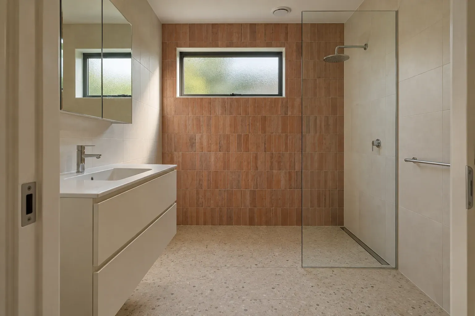 Terracotta tile with an ivory vanity — bathroom design inspiration